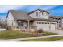 Attractive two-story home featuring a well-manicured lawn and a welcoming front porch at 6313 E 130Th Ave, Thornton, CO 80602