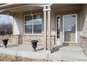 Inviting covered front porch with decorative columns and space for seating at 6313 E 130Th Ave, Thornton, CO 80602