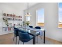 Well-lit dining area featuring a contemporary table and chairs, and bookshelves along the wall at 1300 N Ogden St # 304, Denver, CO 80218