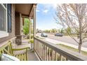 Charming covered front porch with seating and views of the neighborhood street at 1358 14Th Ave, Longmont, CO 80501