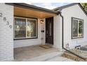 Inviting front porch featuring a stylish front door, brick accents, and a well-manicured entrance at 2839 Ivanhoe St, Denver, CO 80207