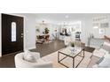 Bright, open living space featuring modern decor, hardwood floors, and seamless transition into the dining area at 2839 Ivanhoe St, Denver, CO 80207