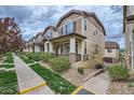 Inviting townhomes with landscaped front yards and charming architectural details at 1436 Turnberry Dr, Castle Rock, CO 80104
