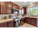 Updated kitchen showcasing stainless steel appliances, ample cabinet space and light countertops at 17035 E 102Nd Pl, Commerce City, CO 80022