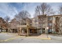 Condo building featuring multiple balconies, covered entrance, and bare trees at 1300 S Parker Rd # 288, Denver, CO 80231