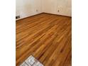 Empty room featuring beautiful hardwood floors and a corner accent at 3323 S Glencoe St, Denver, CO 80222