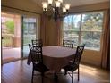Traditional dining room featuring a chandelier and a table covered with a red patterned tablecloth at 15346 Heritage Cir, Thornton, CO 80602