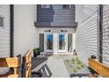 Modern townhome exterior featuring dual front doors with contemporary landscaping and gray and white siding at 5379 W 14Th Ave, Lakewood, CO 80214