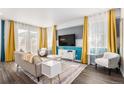 Bright and spacious living room featuring modern decor, large windows, and stylish furniture at 3522 N Buchanan Way, Aurora, CO 80019