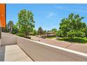 Neighborhood street view from a balcony, showcasing the peaceful surroundings and mature trees at 7684 S Ingalls St, Littleton, CO 80128