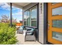Inviting front porch with seating, perfect for enjoying the neighborhood views at 9051 E 61St Ave, Denver, CO 80238