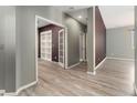 Bright hallway with wood-look floors and built-in shelves at 14442 E 102Nd Pl, Commerce City, CO 80022