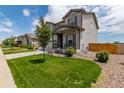 Beautiful two-story home boasting a well-maintained lawn, covered porch, and lush landscaping at 7414 Blue River Ave, Frederick, CO 80530