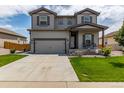 Charming two-story home with a well-maintained lawn, covered porch and attached two car garage at 7414 Blue River Ave, Frederick, CO 80530