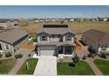 Attractive two-story house with a spacious front yard, two-car garage, and solar panels on the roof at 7414 Blue River Ave, Frederick, CO 80530