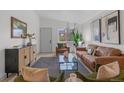 Airy living room with leather sofas, modern furniture, and plenty of natural light at 3619 N York St, Denver, CO 80205