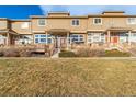 Charming townhouse showcasing a well-maintained lawn and inviting front porch at 9752 Dahlia Ln, Thornton, CO 80229
