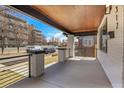 Welcoming covered front porch with modern railings, painted brick columns, and stylish lighting at 1317 Monroe St, Denver, CO 80206