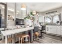 Bright, well-lit kitchen area also used as home office with desk, chair, and modern appliances at 4685 Wadsworth Blvd, Wheat Ridge, CO 80033