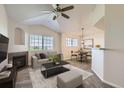 Bright living room with fireplace, vaulted ceilings and modern decor at 5705 N Genoa Way # 308, Aurora, CO 80019
