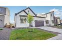 Charming two-story home with a well-manicured lawn and a modern garage at 5930 S Platte Canyon Dr, Littleton, CO 80123