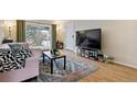 Bright living room featuring a plush sofa, stylish rug, and sliding glass doors with views of the outdoors at 2125 S Gilpin St, Denver, CO 80210