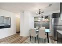 Bright dining area featuring a modern light fixture and a large window at 8035 W Eastman Pl # 106, Lakewood, CO 80227