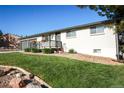 Charming single story home featuring a well-kept front yard, flowers, and a cozy front porch at 7100 Saulsbury St, Arvada, CO 80003