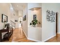 Inviting foyer featuring hardwood floors and an attractive plant niche at 9825 S Iris Ct, Littleton, CO 80127