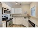 Well-lit kitchen with stainless steel appliances and white cabinets at 10784 W 63Rd Pl # 204, Arvada, CO 80004