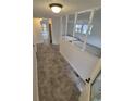 Inviting entryway with neutral-toned tile flooring, white walls, and views to the living room and fenced backyard at 14190 E Gunnison Pl, Aurora, CO 80012