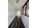Inviting hallway features modern wood-look floors and a decorative half wall at 14190 E Gunnison Pl, Aurora, CO 80012
