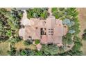 Gorgeous aerial view of the property with lush landscaping, tile roof, and peaceful backyard at 28 Indian Paintbrush Dr, Golden, CO 80401