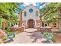 Beautiful home exterior with stone accents, arched entryway and stunning double front door at 28 Indian Paintbrush Dr, Golden, CO 80401