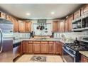 Well-lit kitchen featuring updated appliances, custom cabinetry, and stylish countertops at 4365 Kendall St, Wheat Ridge, CO 80033