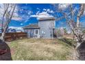 Expansive backyard space with a lush lawn and mature trees, offering plenty of room for recreation at 1655 Hermosa Dr, Highlands Ranch, CO 80126