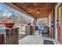 Inviting front porch with wood ceiling and brick columns at 579 S Sherman St, Denver, CO 80209