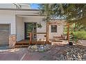 Covered front porch, a swing and a stone pathway welcome you to this charming home at 31518 Niakwa Rd, Evergreen, CO 80439