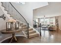 View of the home foyer and hardwood floors, with a staircase and an open living space at 10397 Helsinki St, Parker, CO 80134