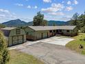 Ranch-style home with a detached garage and mountain views at 30651 Hollings Way, Golden, CO 80403
