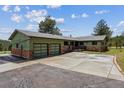 Home with a two-car garage and stone accents at 30651 Hollings Way, Golden, CO 80403
