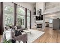 Bright living room with tall windows, fireplace, hardwood floors, and modern decor at 10765 Fremont Dr, Parker, CO 80134