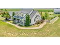 Charming home with a covered front porch and manicured landscaping, highlighting its curb appeal at 56920 E 42Nd Ct, Strasburg, CO 80136