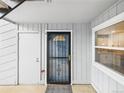 Apartment entrance with security door, and view to kitchen through the window at 7205 S Gaylord St # G, Centennial, CO 80122