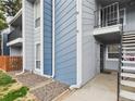 Apartment exterior with blue and gray siding, and stairs to the upper level at 7205 S Gaylord St # G, Centennial, CO 80122