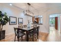 Elegant dining room featuring a modern chandelier and an open view into the kitchen at 222 S Monroe St, Denver, CO 80209