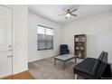Bright living room featuring modern furniture, ceiling fan, and ample natural light at 22046 E Allenspark Pl, Aurora, CO 80016
