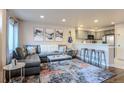 Open-concept living room featuring stylish furniture and seamless flow to the kitchen at 5316 Stuart St, Denver, CO 80212