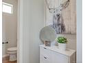 Cozy powder room featuring modern decor, white cabinet, and a charming deer print at 1218 Sugarloaf Ln, Erie, CO 80516
