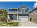 Charming two-story home with a manicured front yard and attached two-car garage at 2417 Mountain Sky Dr, Fort Lupton, CO 80621